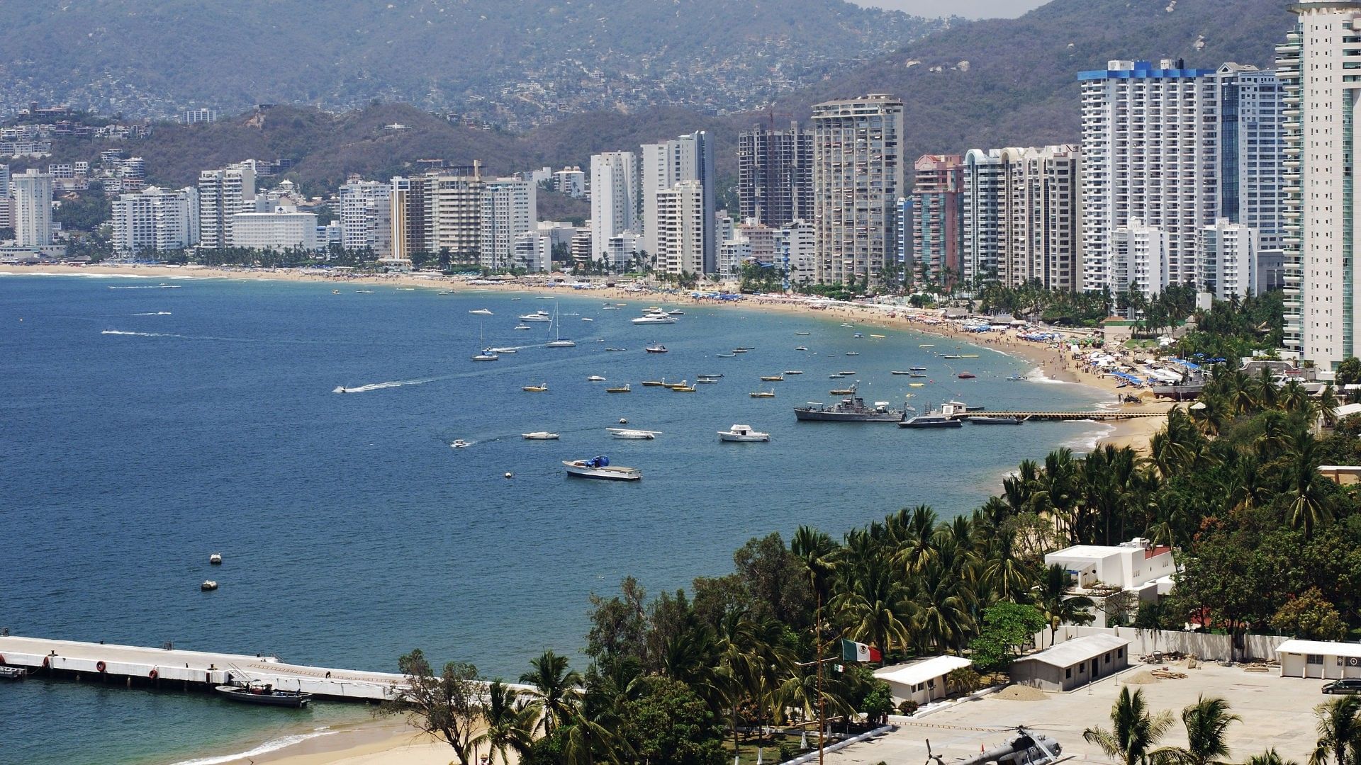 Stunning aerial view of Forum Mundo Imperial and high-rise city skyline near Quinta Real Acapulco