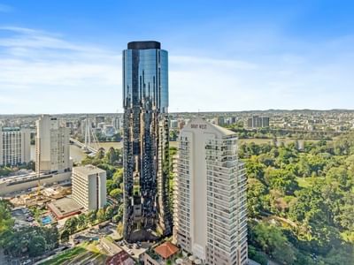 Elevated view of UniLodge Brisbane City surrounded by greenery and other high-rise buildings.