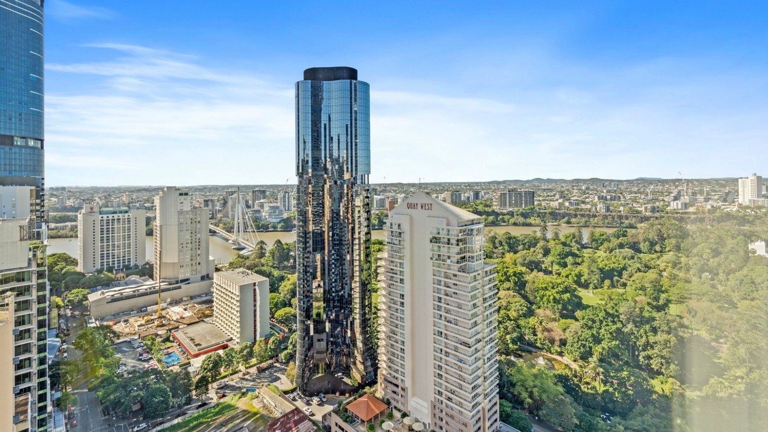 Elevated view of UniLodge Brisbane City surrounded by greenery and other high-rise buildings.