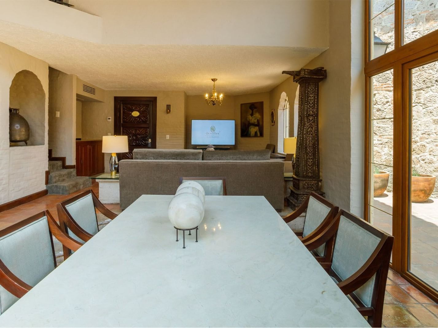King Presidential Suite with marble table, stone pillars, and terrace access at Quinta Real Guadalajara

