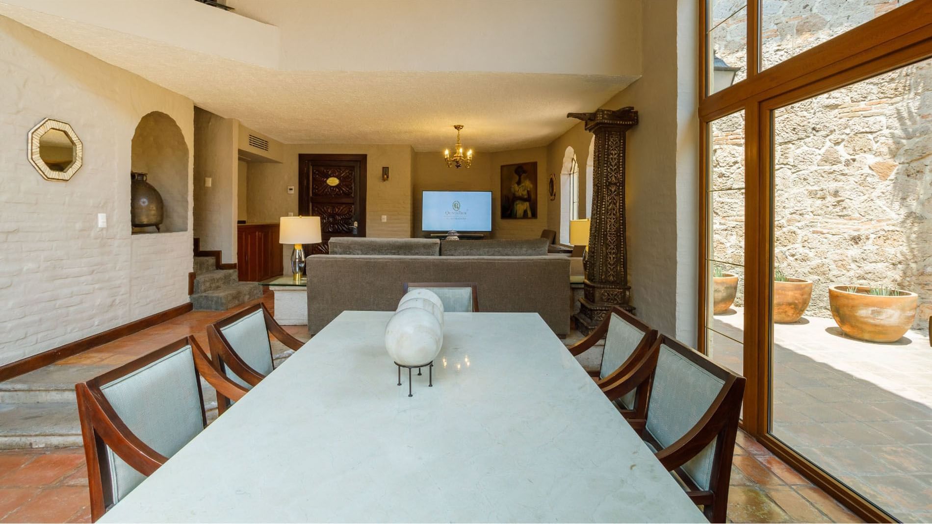 King Presidential Suite with marble table, stone pillars, and terrace access at Quinta Real Guadalajara
