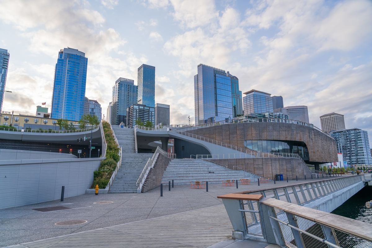 Concrete stairs by a modern building under a cloudy sky in a city plaza,near Warwick Seattle