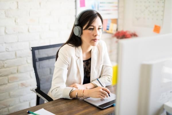 Women listening to music in the workplace whilst working