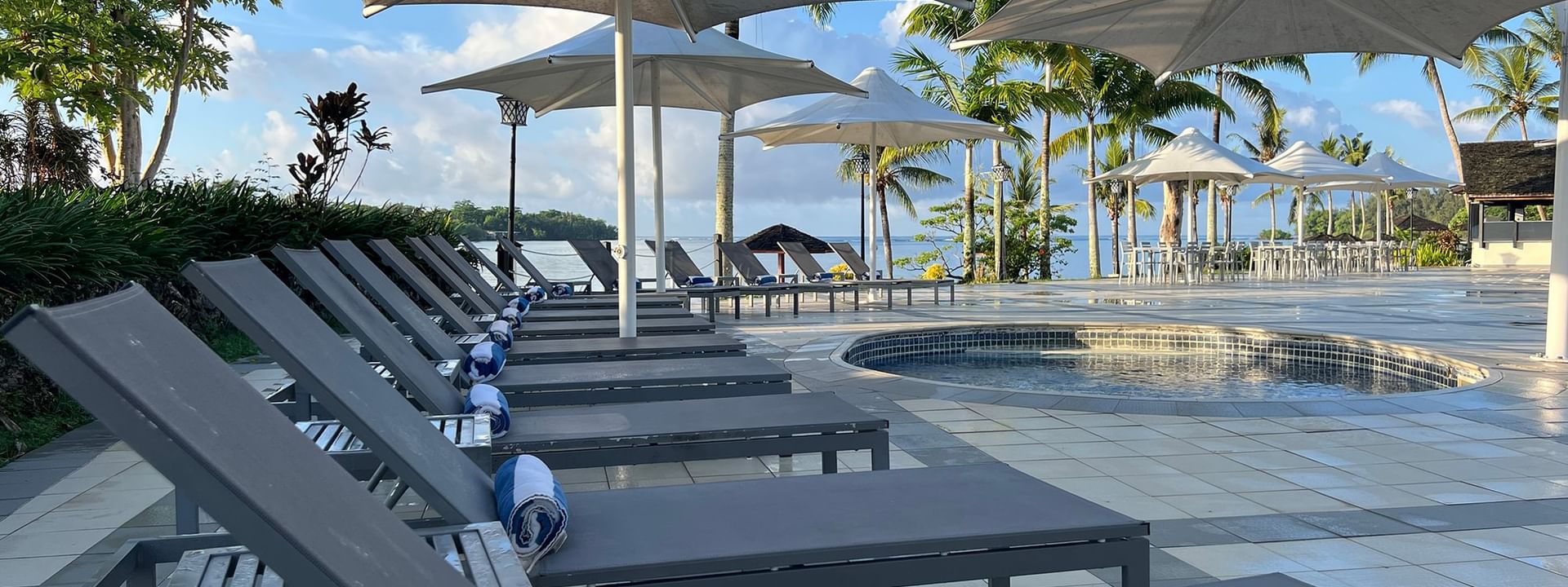 Poolside with loungers and umbrellas at Warwick Le Lagon - Vanuatu in Efate
