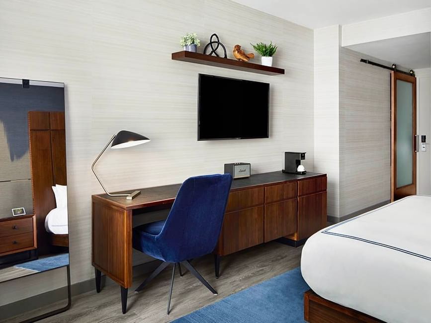 Deluxe Room featuring a Mirror, TV, Work desk with a lamp, and a chair at Gansevoort Meatpacking NYC