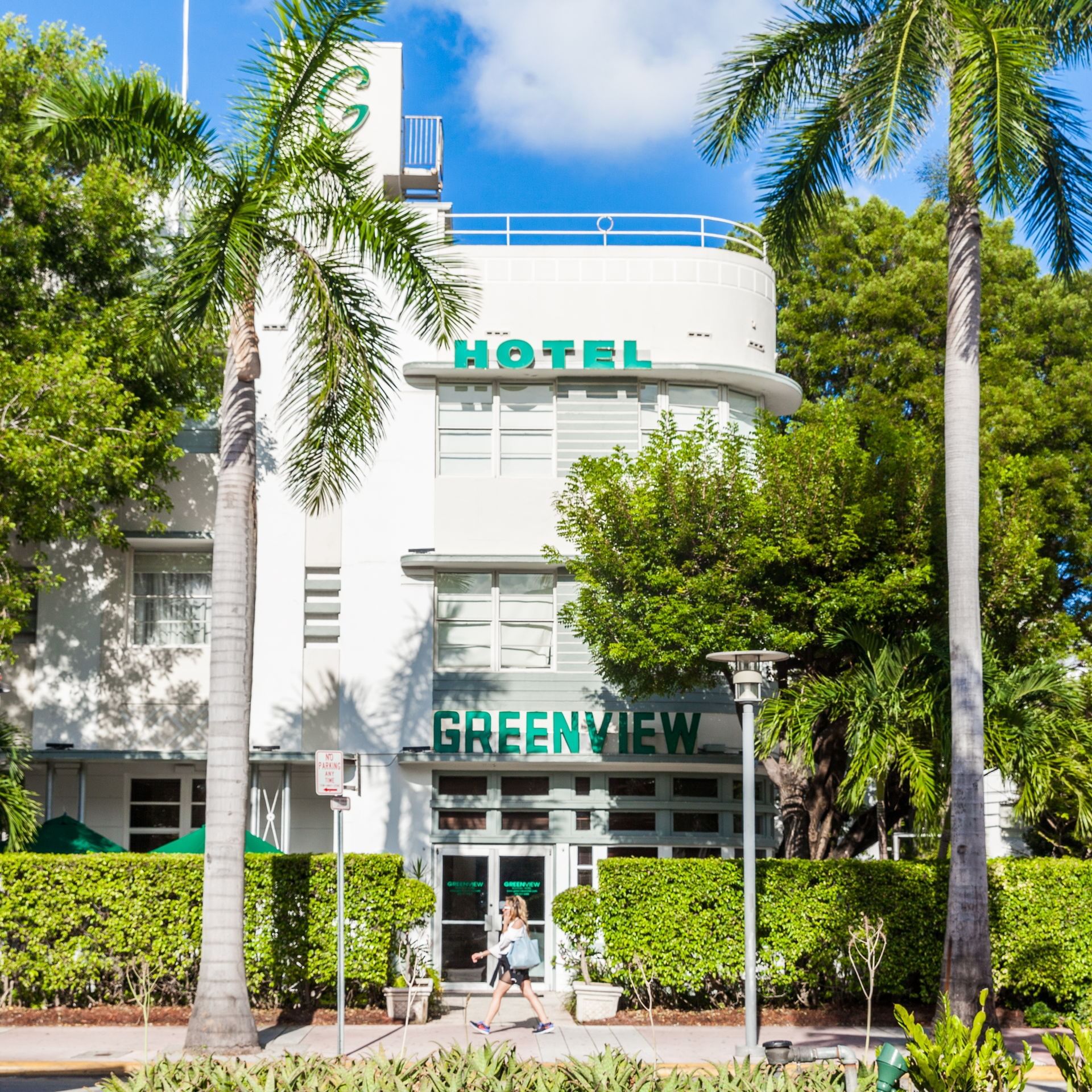 Palm trees surrounding the building of Greenview Boutique Hotel