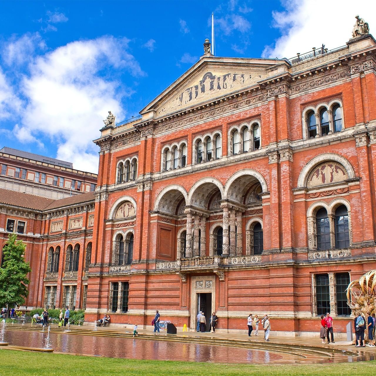 Brick exterior of the V&A Museum with ornate arches near The Capital Hotel, Apartments and Townhouse