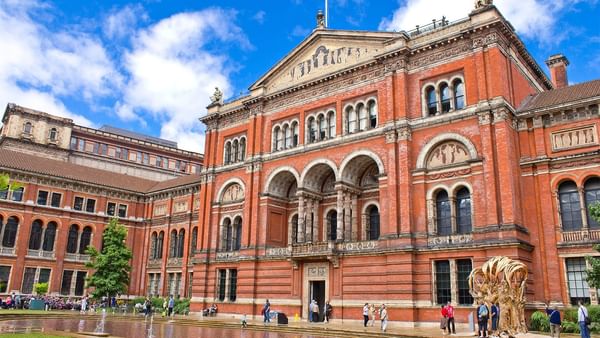 Brick exterior of the V&A Museum with ornate arches near The Capital Hotel, Apartments and Townhouse