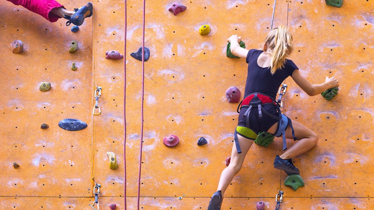woman climbing on an indoor climbing wall