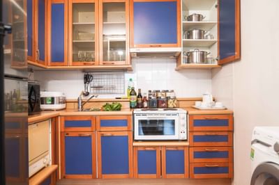Kitchen with blue cabinets & refrigerator at Hanoi Daewoo Hotel