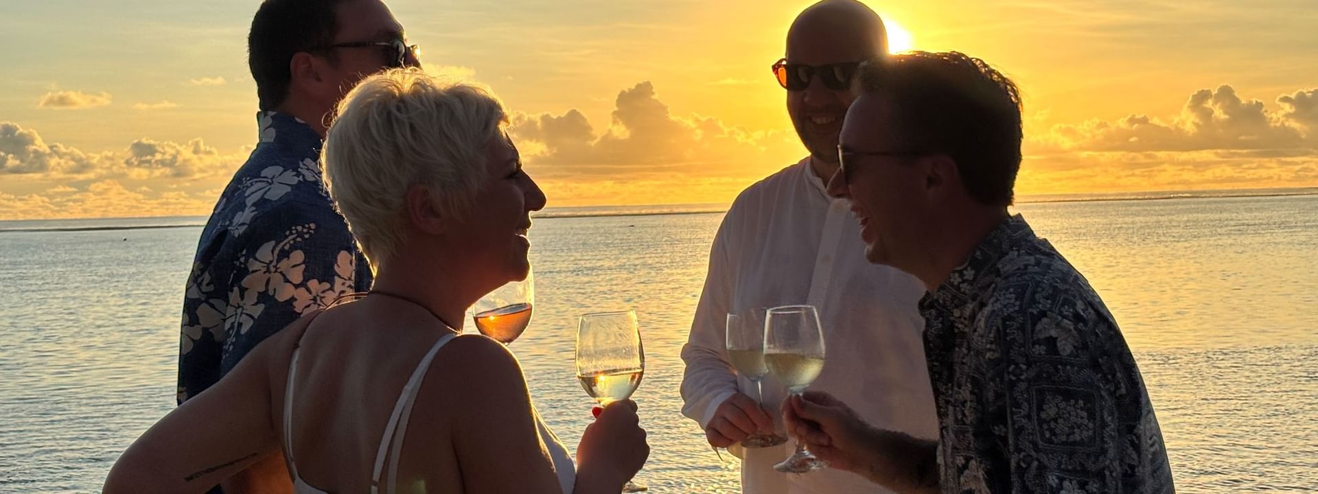 Guests enjoying a sunset wine tasting by the ocean at Warwick Fiji Resort and Spa