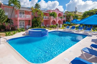 Sunbeds & palm trees by the outdoor pool area at Dover Beach Hotel