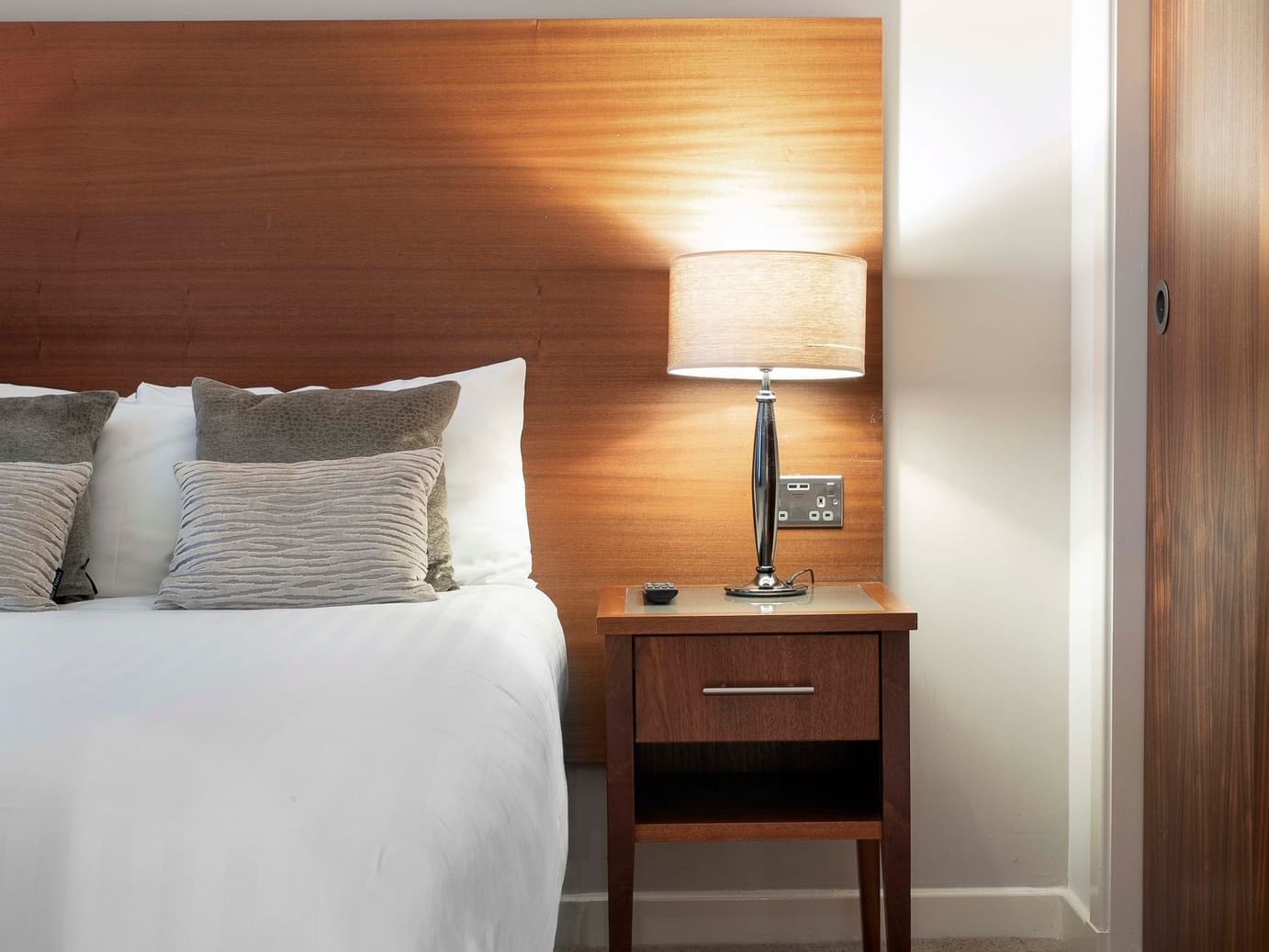 A table lamp near a bed at Stewart Aparthotel Edinburgh