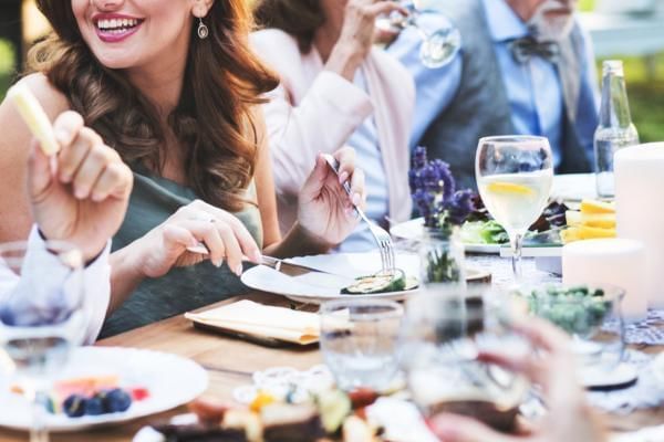 Wedding guests eating simplified menu, a great way to save money on a wedding