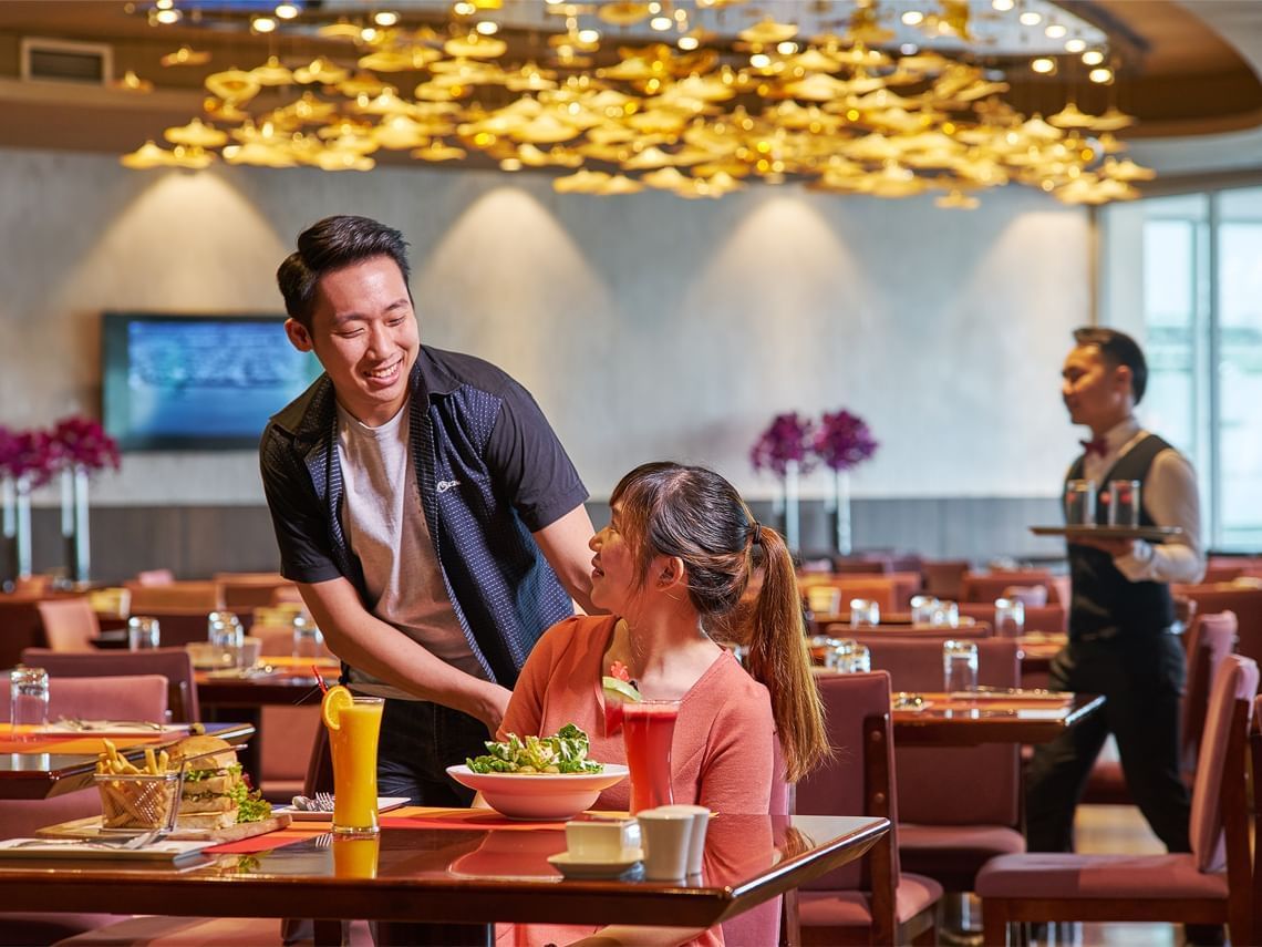 Couple fine dining at hotel restaurant for buffet dinner