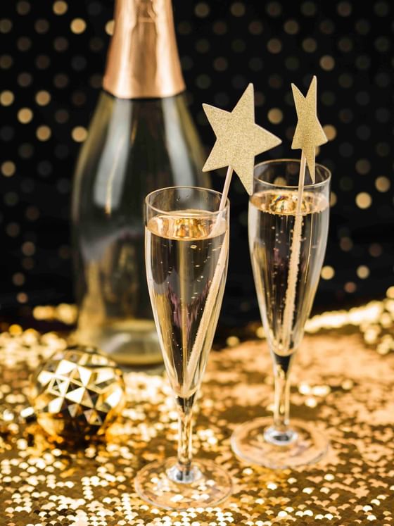 Close-up of Champagne & glasses on a golden star fabric at The Danna Langkawi