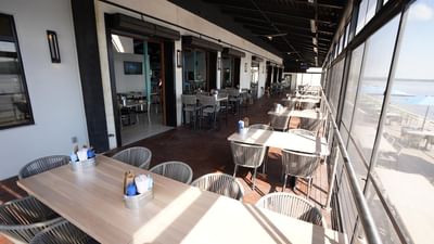 Restaurant Indoor Patio arranged with white seating at Off Shore Resort