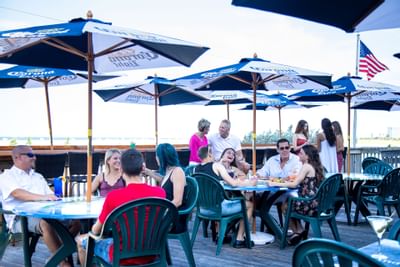 groups of people sitting at tables outside