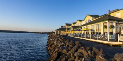 Resort patio by a rocky shore under a blue sky at Rodd Miramichi River, perfect for Miramichi, Canada hotels