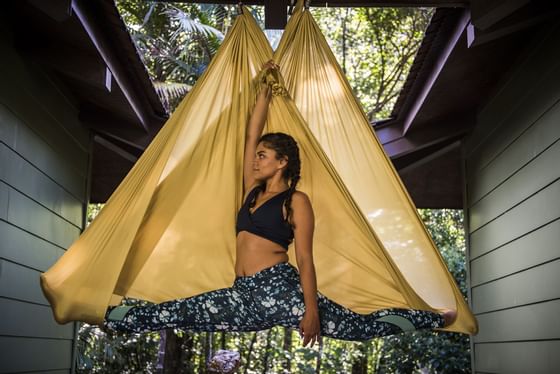 woman hanging from silks