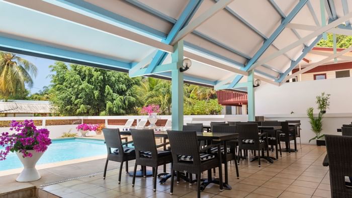 An outdoor dining area by the pool at Hotel Belova