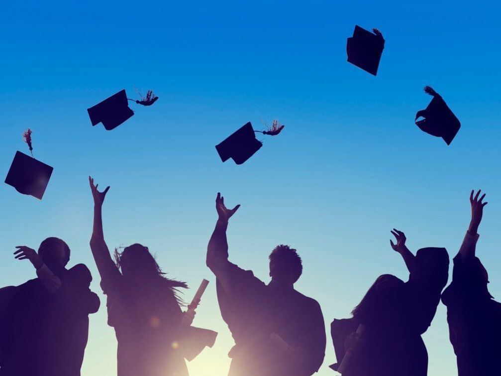 Students throwing graduation hats at Carlton Hotel Singapore