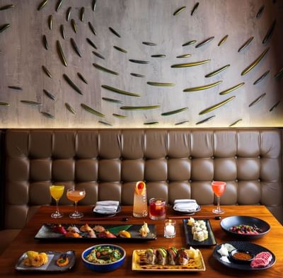 Cuisines served with cocktails & Fish wall at Eliot Hotel
