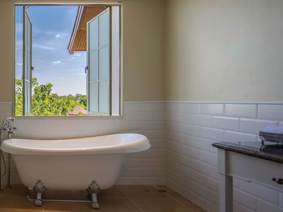 Bathtub by the window in Family Room at U Hotels and Resorts