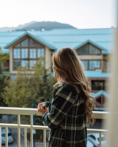Woman standing on the balcony at Summit Lodge