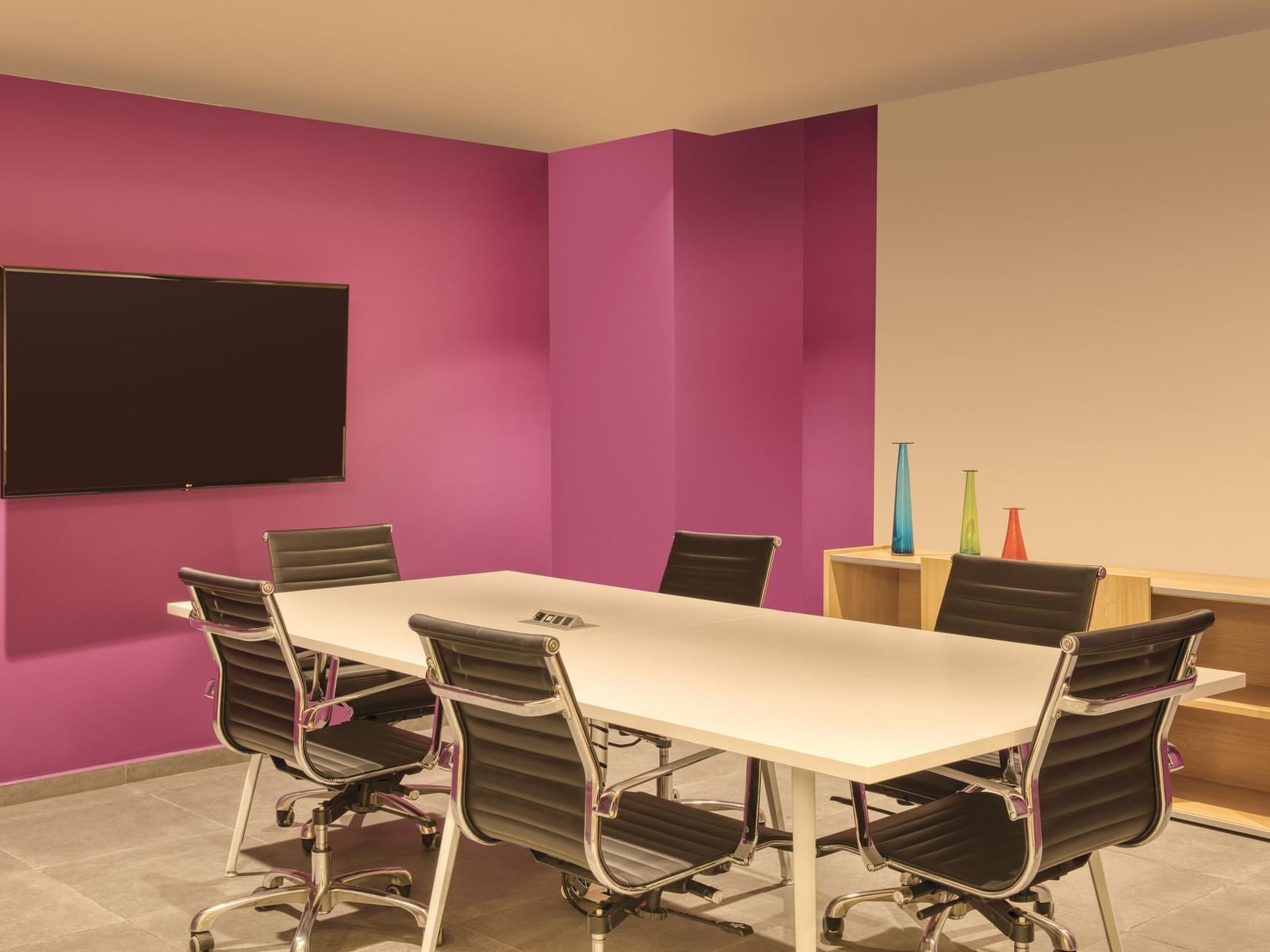 Conference table & Tv in a Business Center at Fiesta Inn Hotels