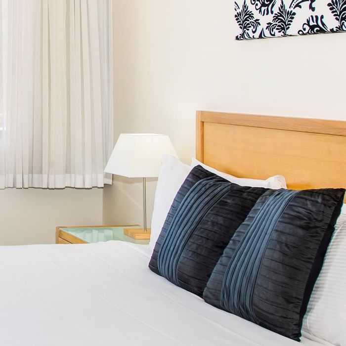 The bedroom arrangement in Privilege King room with a window overlooking the view at Mercure Charlestown