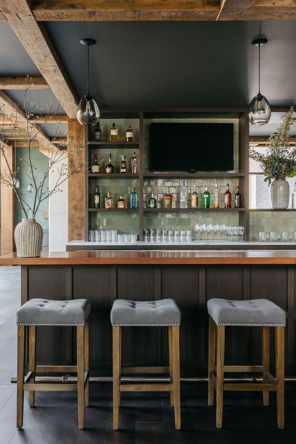 Truth Be Told with bar counter and shelves of liquor bottles in The Study at the University of Chicago