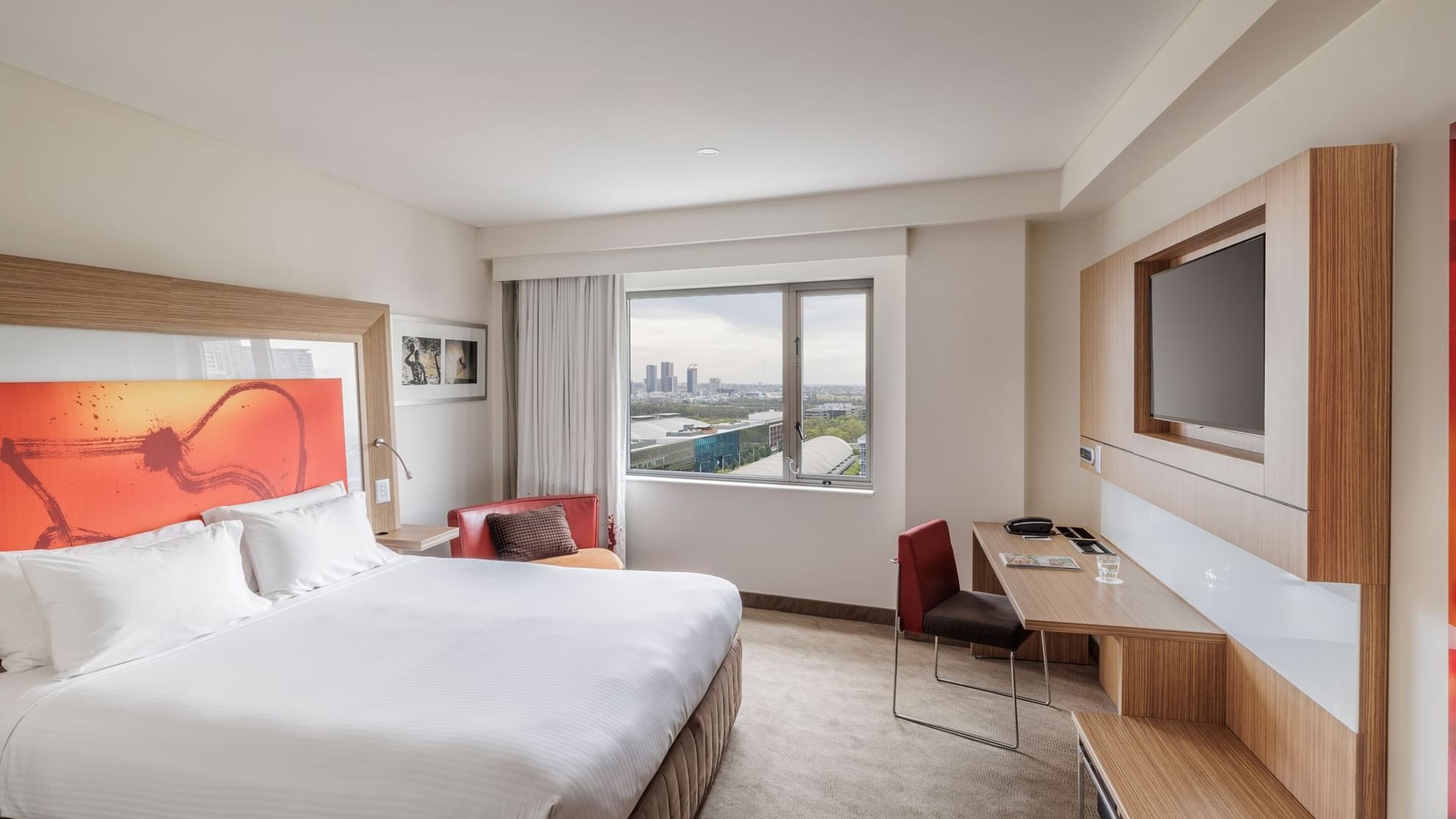 TV and work desk by the comfy bed in Superior Accessible Room with views of Accor Stadium at Novotel Sydney Olympic Park