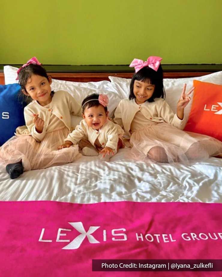 a few kids sitting on the bed at Lexis Port Dickson