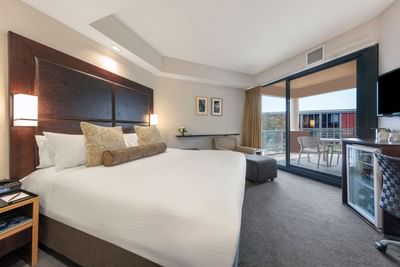 Bed & balcony in 2 Bedroom Apartments at Amora Hotel Melbourne
