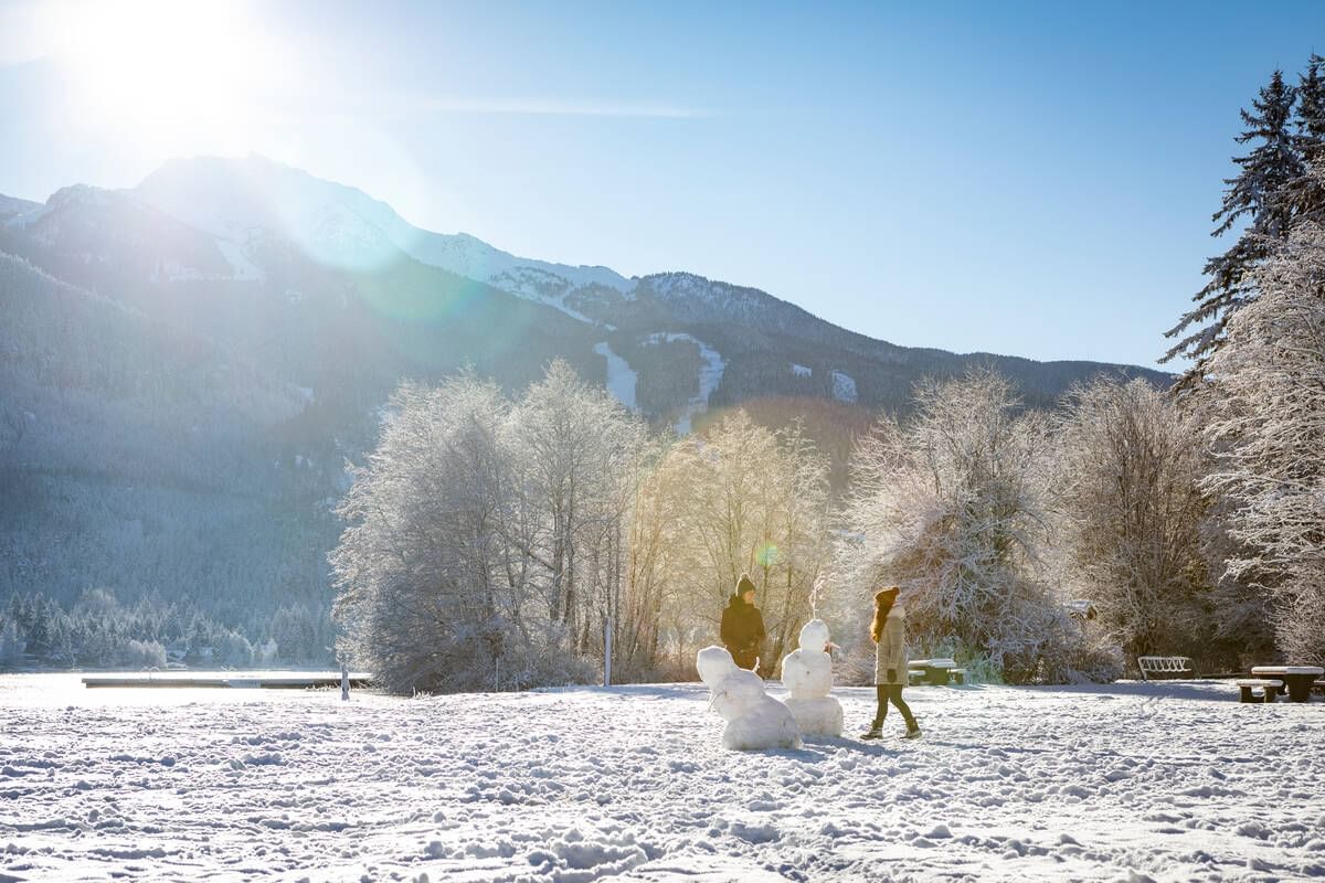 Distant view of women making snowmen near Blackcomb Springs Suites