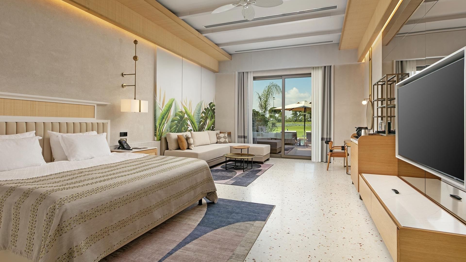 TV & seating area by the bed in Lagoon Golf Family Swim-up at Cullinan Belek