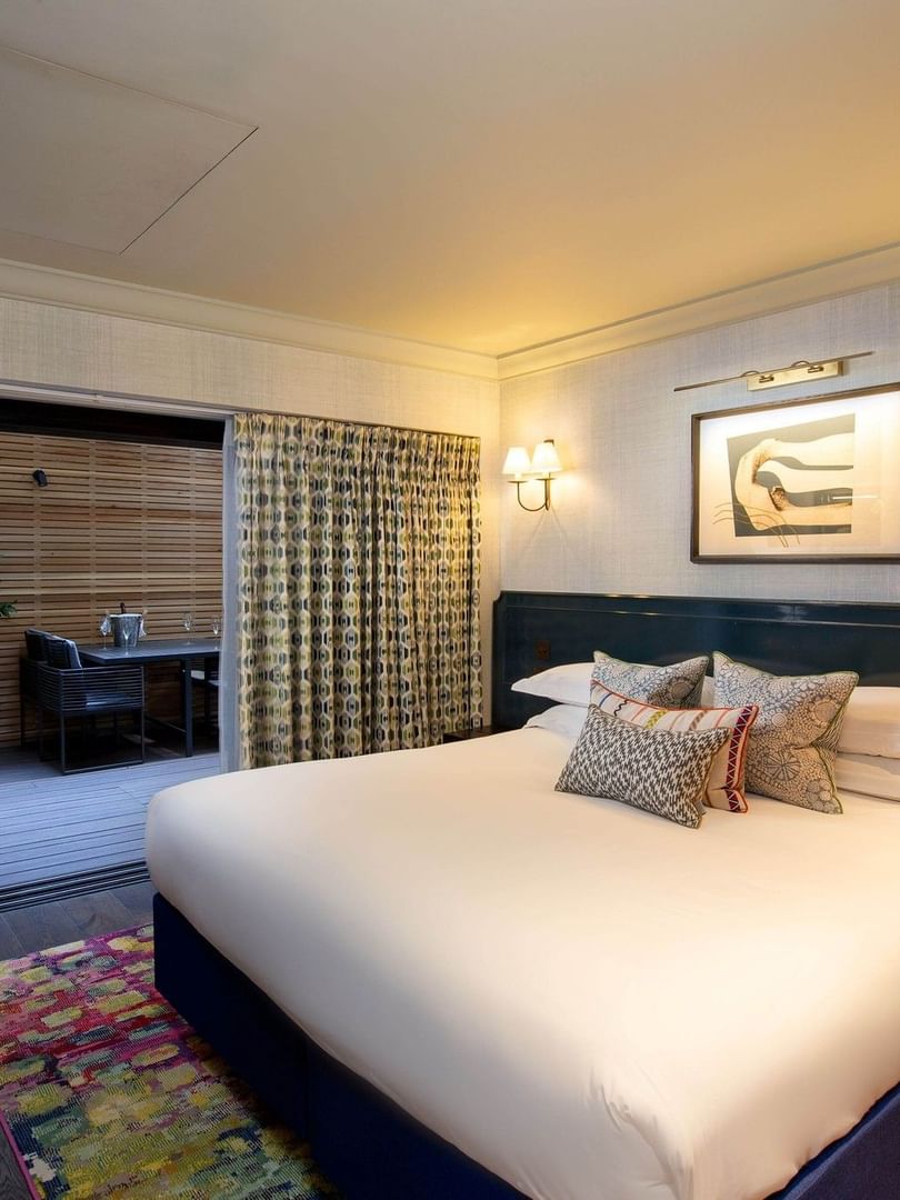Modern guest room with king bed, private outdoor terrace, and contemporary decor for Stay Sunday & Save Warwick Weekends.