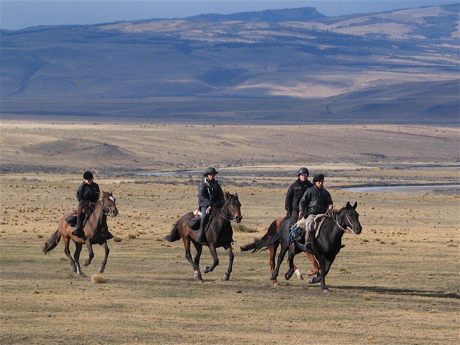 4 men on horses at the Estancia near NOI Indigo Patagonia