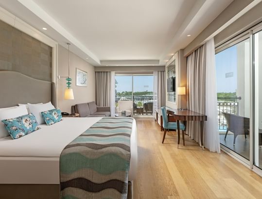 TV, sofa & work desk by the bed in Riverside Room at Titanic Deluxe Golf Belek