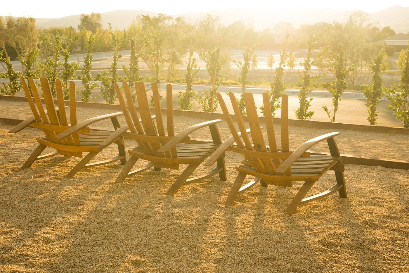 Lounge chairs looking over the bocce ball court with a setting s