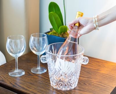 Lady placing a Champaign bottle in ice at Costa Beach Resort