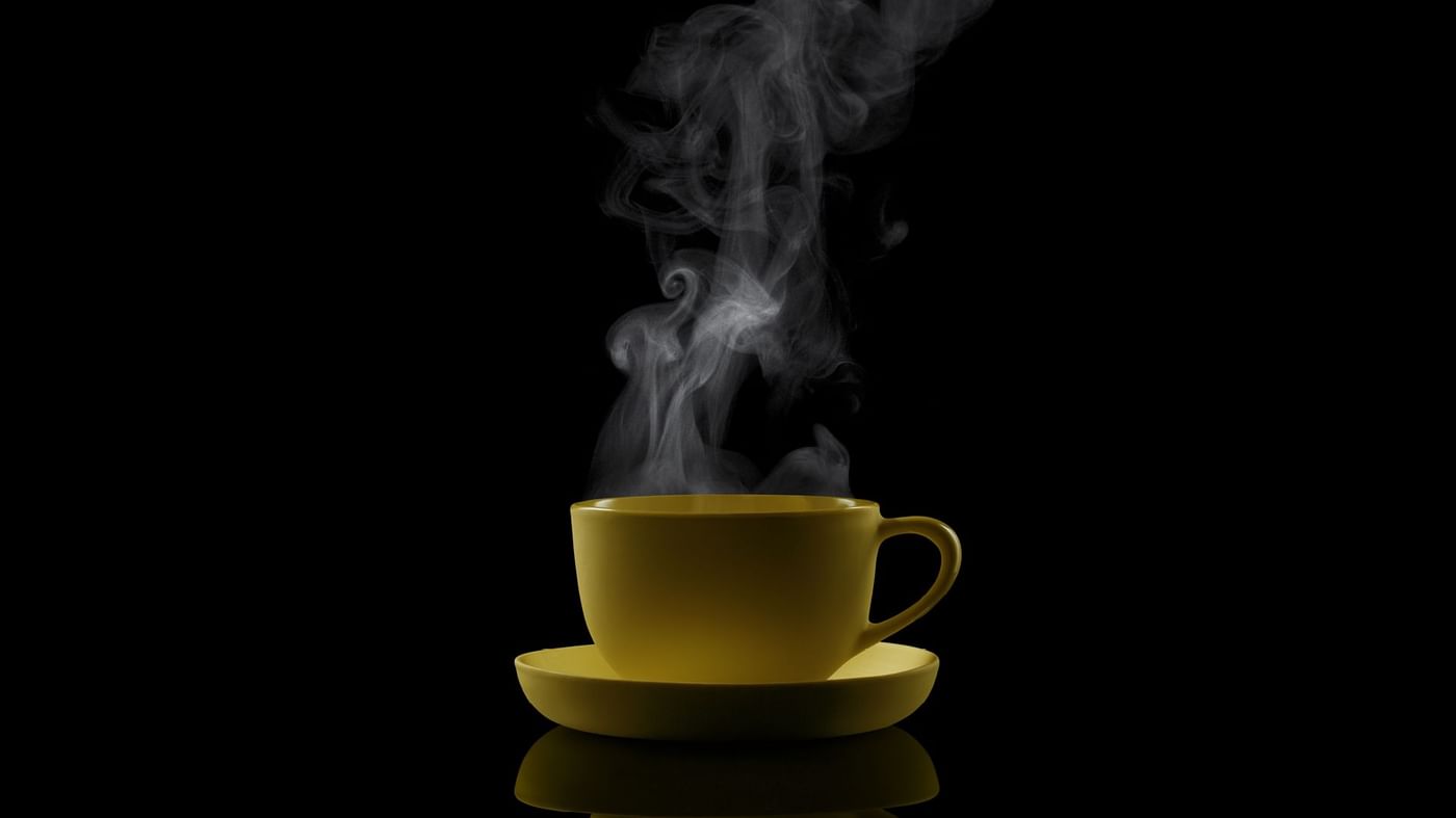 Close-up of a hot tea served in a black background at Crown Hotels