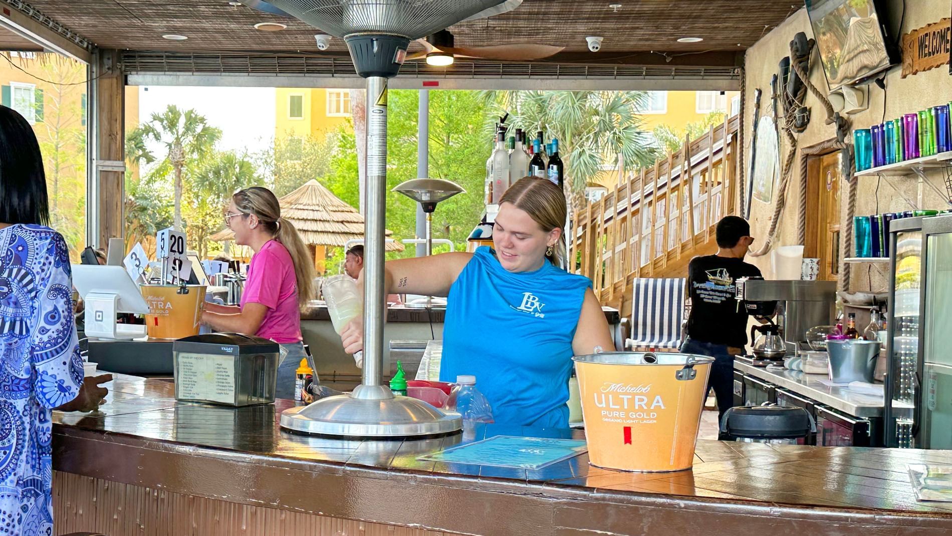 Bartenders and work area in LBV Village Bar & Grill at Lake Buena Vista Resort Village & Spa