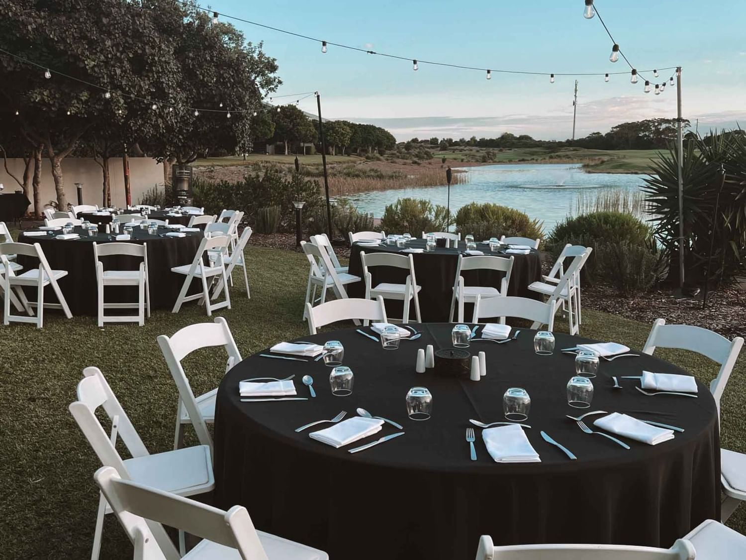 Round dining tables arranged by the lake at Pullman Magenta Shores