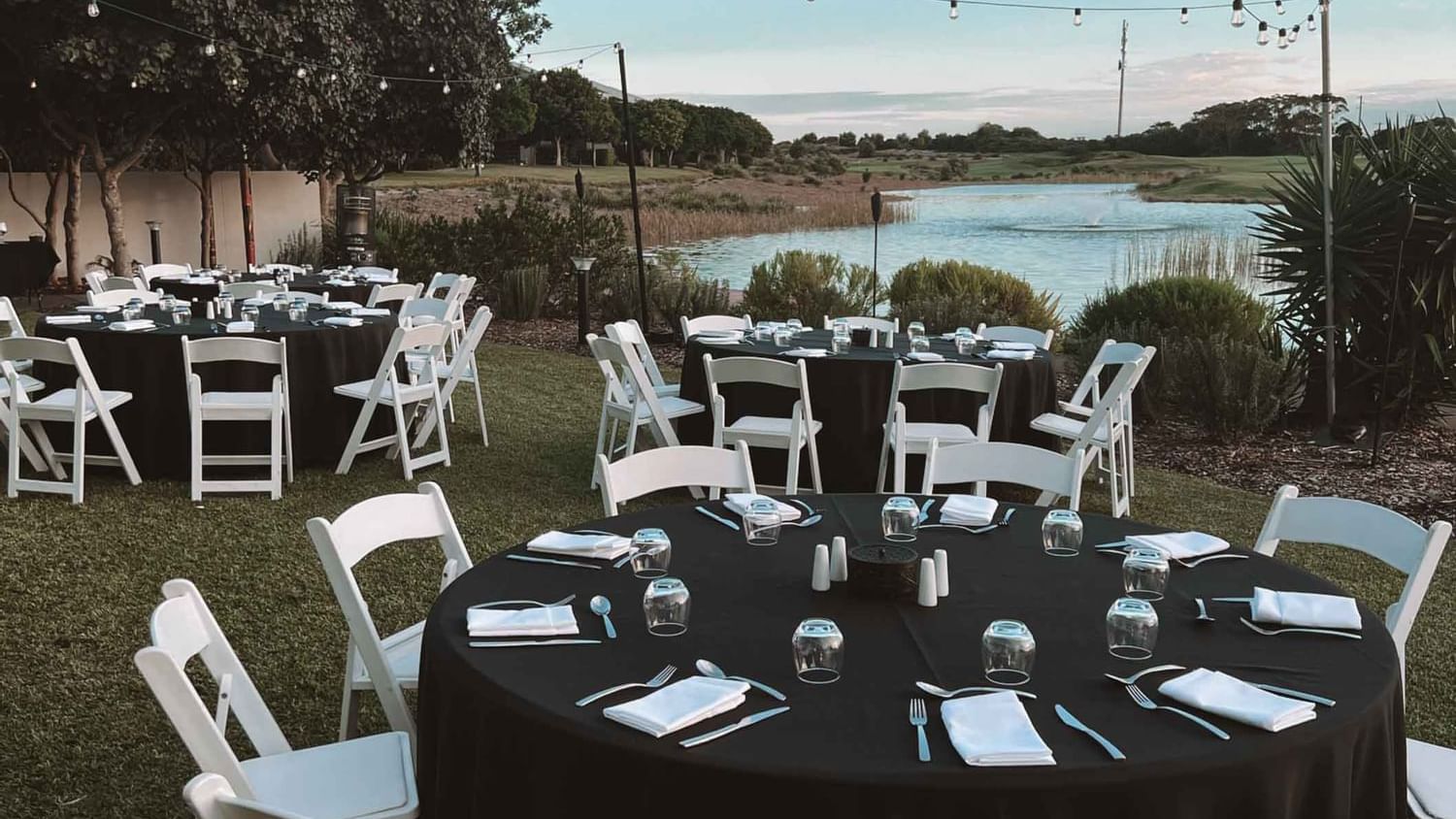 Round tables arranged by the lake at Pullman Magenta Shores
