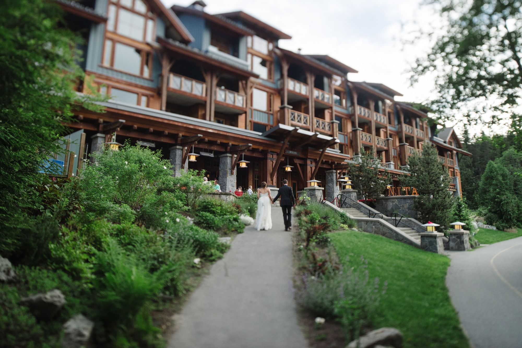 Bride & Groom walking in the hotel entrance at Nita Lake Lodge