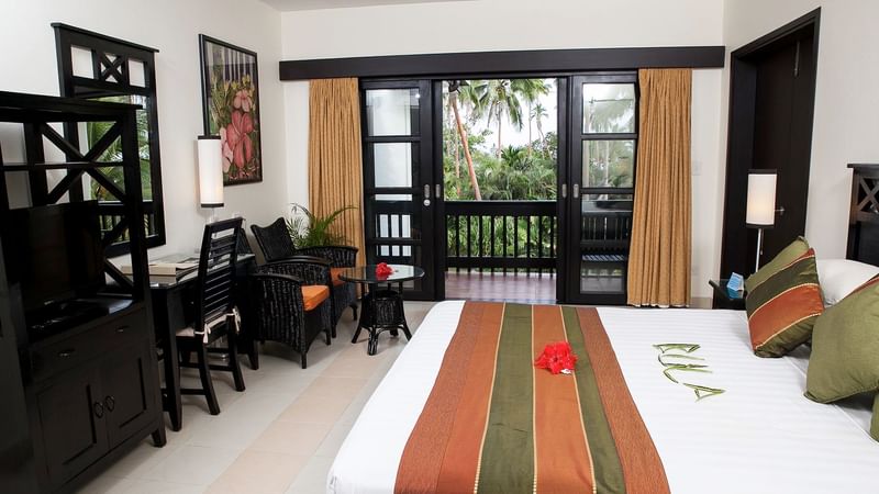 Bedroom arrangement in a Suite at The Naviti Resort