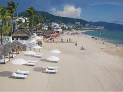 buildings and people walking along a beach