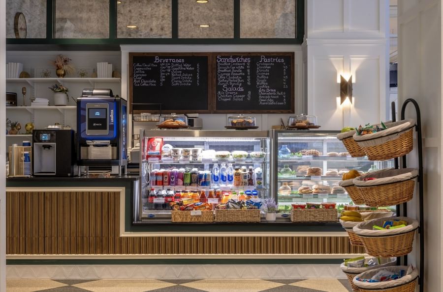 Beverage and pastry display cases with snacks in baskets at Allerton Cafe and Lounge in Warwick Allerton Chicago 
